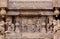 Ancient carvings with dancing women in Indian style, on ceremonial cart of Hindu temple. Old structure in India