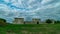 Ancient castle stands in the middle of green lawn at summer day filmed in timelapse