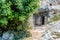 Ancient cemetery in the city of Limyra, Turkey. The entrance to the old concrete tomb in the rock. Excursion to the