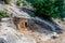 Ancient cemetery in the city of Limyra, Turkey. The entrance to the old concrete tomb in the rock. Excursion to the