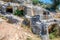 Ancient cemetery in the city of Limyra, Turkey. The entrance to the old concrete tomb in the rock. Excursion to the