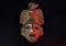An ancient ceramic pre columbus mask based in American indigenous tribes art iluminated by red light