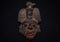 An ancient ceramic pre columbus mask based in American indigenous tribes art iluminated by red light inside and white light