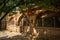 Ancient Chinese folk kiln caves under the shade of trees.