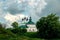 Ancient Church of the Entrance to Jerusalem and Pyatnitskaya Church, Suzdal. View from the hill in summer on a cloudy day