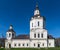 Ancient church with white walls against the blue clear sky