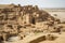 ancient city in the desert, with towering stone structures and intricate carvings