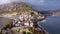 Ancient city with red rooftops buildings located on the shore of Egirdir lake filmed from above