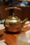 Ancient classic teapot on the restaurant table