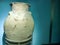 Ancient clay vase with cracks. Museum piece. vase with hand-painted top and large cracks. interior vase against a blue matte wall