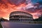 ancient colosseum in rome with dramatic sunset sky