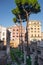 Ancient column ruins surrounded by modern streets in Rome, Italy