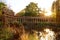 The ancient columns of Parc Monceau are reflected in the water of the oval basin, in the sun . This public garden is located in