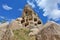 Ancient conical rock of Cappadocia against blue sky.