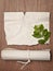 Ancient crumpled paper scroll on wood table with green leaf for background