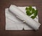 Ancient crumpled paper scroll on wood table with green leaf for background