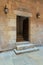 Ancient decorated bricks stone wall and doorway leading to the House of Egyptian Architecture historical building, Cairo, Egypt