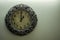 Ancient Designer Wall Clock With Light Yellow Back Ground showing time 01.00 o`clock and free space on right side