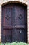 Ancient door forged dark natural wood with latch lock round hand