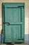 Ancient door in green color, cracked wooden entrance, sample for post card