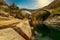 Ancient double arch stone Roman bridge (Ponte dei Salti) over the Verzasca River in Lavertezzo