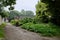 Ancient dwelling houses by road in verdant summer green