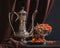 Ancient East metallic crockery - vintage jug for tea, vase with dried fruit and plate with tea in glasses