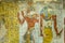Ancient egyptian painting of two gods in a tomb in the valley of