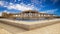 Ancient Egyptian pharaohs palace with stone columns and a large blue water pool. 3D rendering