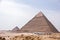 Ancient Egyptian pyramids of Giza against blue sky