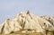 Ancient eroded white and pink sandstone rock formations in Cappadocia valley, Turkey