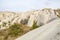 Ancient eroded white and pink sandstone rock formations in Cappadocia valley, Turkey