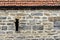 Ancient exterior stonework wall showing a vertical slot.