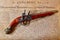 Ancient flintlock pistol and the Declaration of Independence