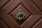 Ancient  forged knocker closeup detail on the wooden entrance door. Rothenburg ob der Tauber