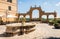 Ancient Fountain and arches in Repubblica square, in Pitigliano, Italy