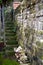 Ancient garden access from stone staircase and natural stone wall with moss and weeds