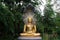 Ancient Golden Buddha Image Protected by the Hood of the Mythical Serpent or Naga in the Garden.