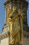 Ancient golden sculpture of angel with cross