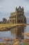 Ancient gothic english abbey with reflection in lake