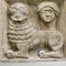 Ancient greco roman relief of mythical lion and human head build into wall