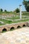 Ancient Greece city Dion. Column in ruins of House of Dionysos. Archaeological park of sacred city of Macedon