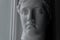 Ancient greek sculpture white plaster copy head of diana in light of window