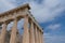 Ancient Greek Temple of Aphaia against a cloudy blue sky