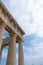 Ancient Greek Temple of Aphaia against a cloudy blue sky