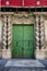 Ancient green wooden door of Alicante town hall, Spain