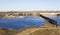 Ancient gun on a background of a dam and hydroelectric power plants