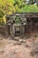 Ancient half-ruined stone gate in a forest