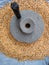 An ancient hand mill made of stones and wood. Flour grinding device. Authentic handicraft