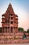 ancient hindu temple architecture with girl witnessing it at evening from flat angle at day